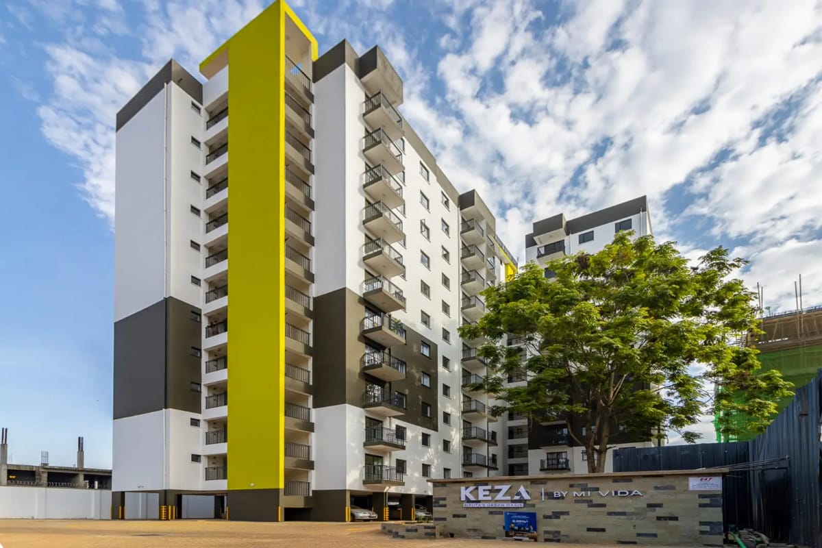 Modern multi-story residential building with yellow accent stripe