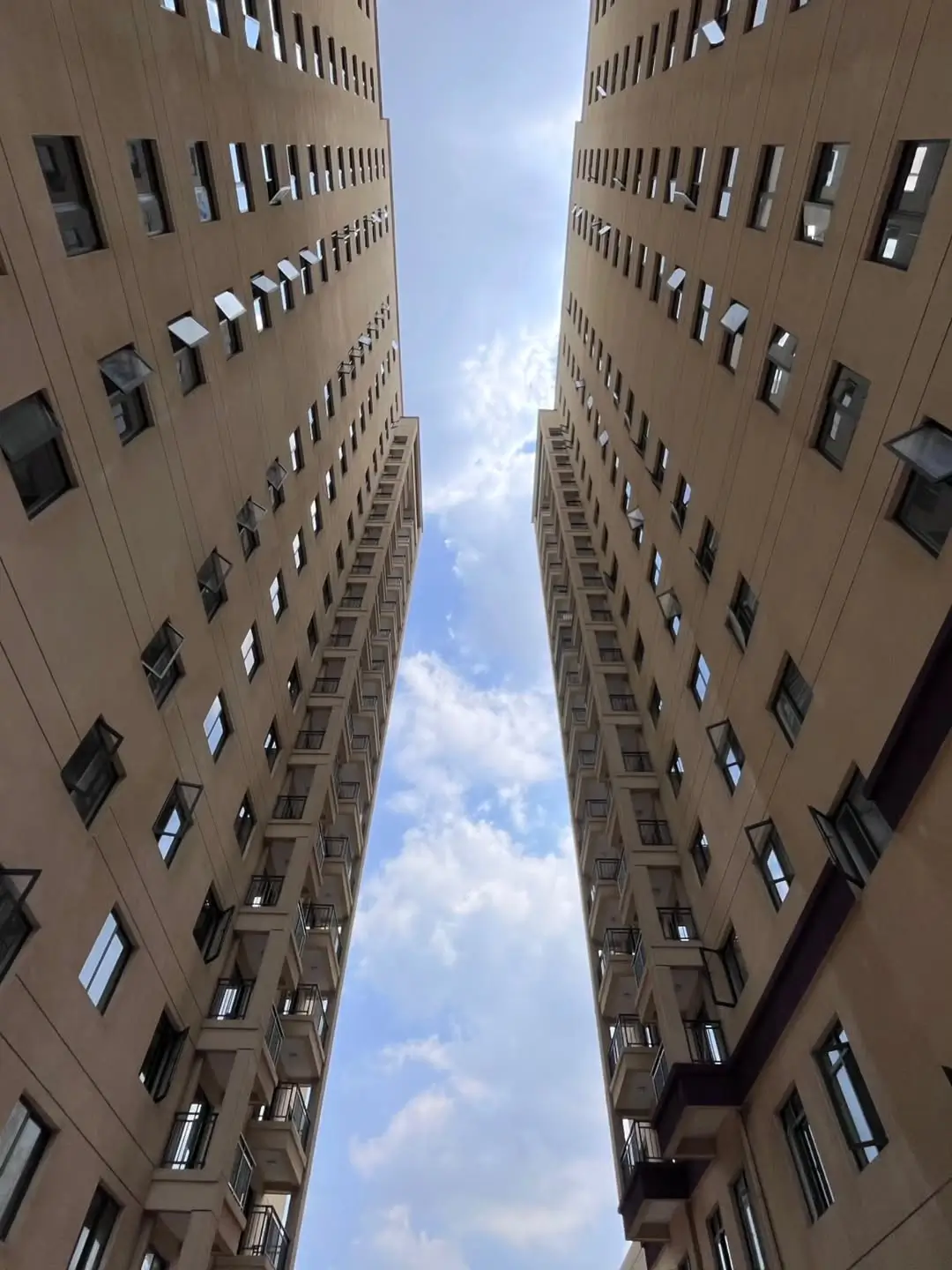 Tall residential building facade with uniform window grid pattern