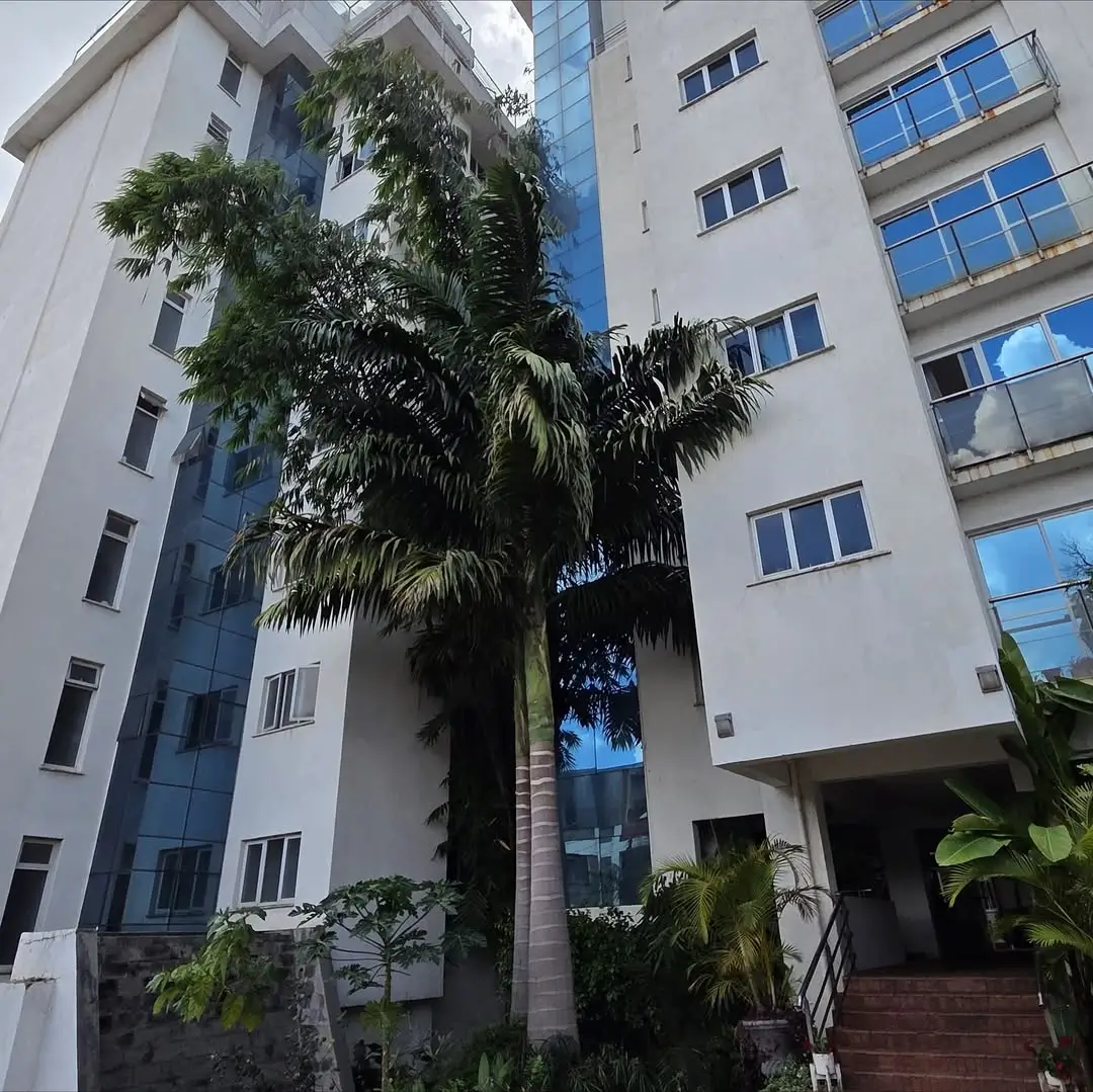 Modern residential building facade with palm tree courtyard
