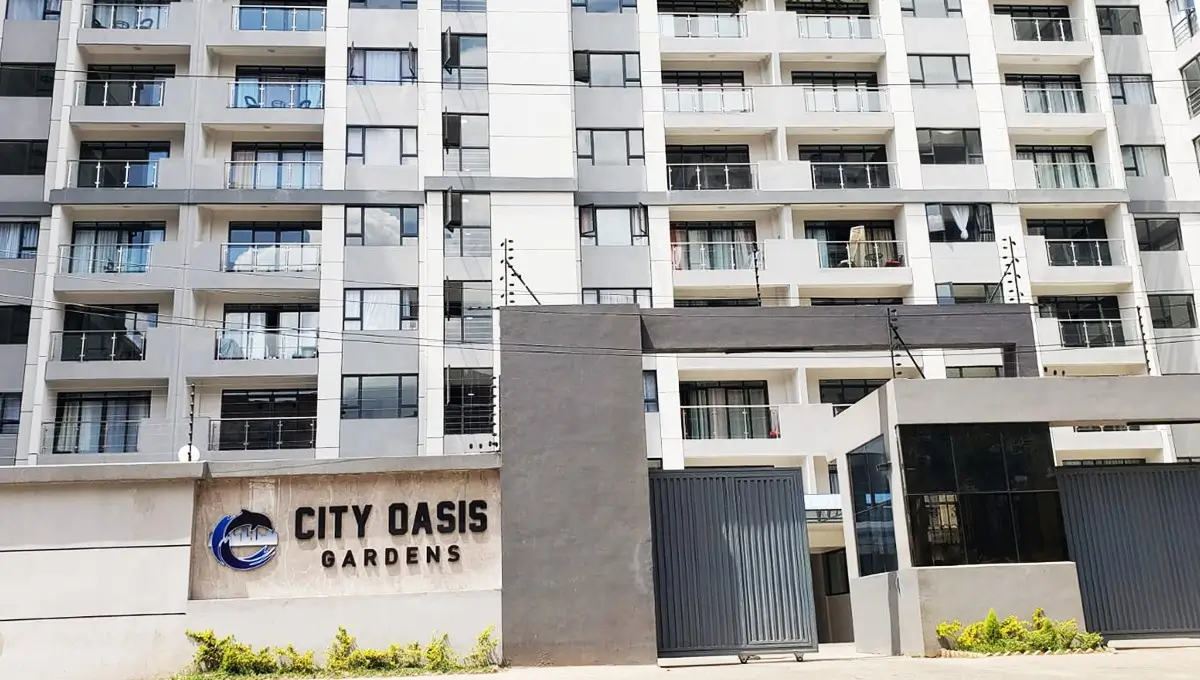 Modern multi-story residential building facade with entrance gate
