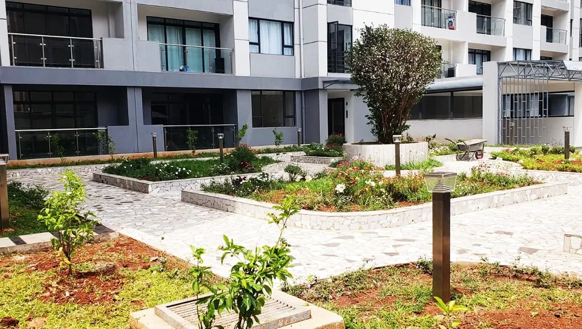 Landscaped compound grounds with paved walkways and planted trees