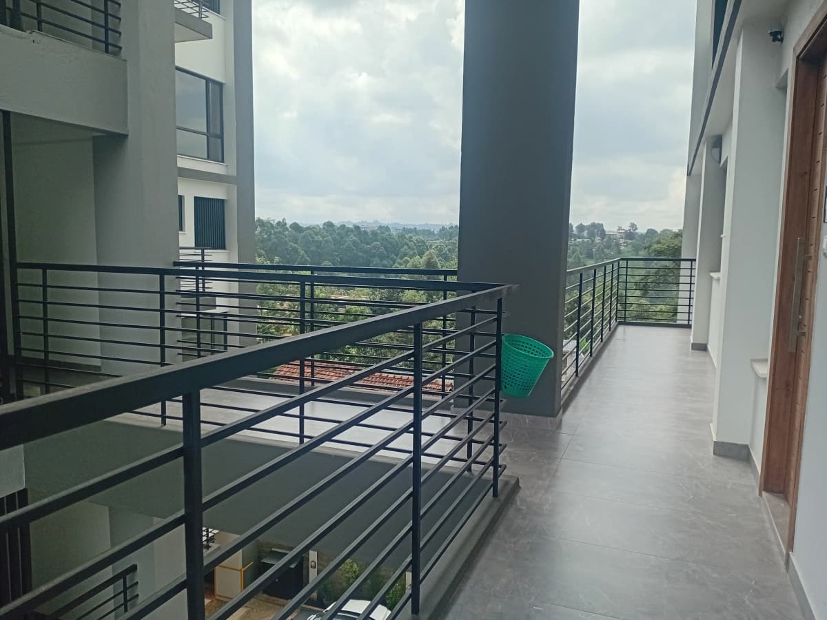 Modern balcony with metal railings overlooking green landscape