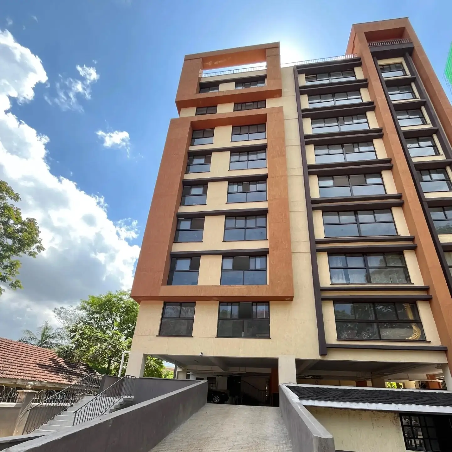 Modern multi-story residential building with brick and cream facade