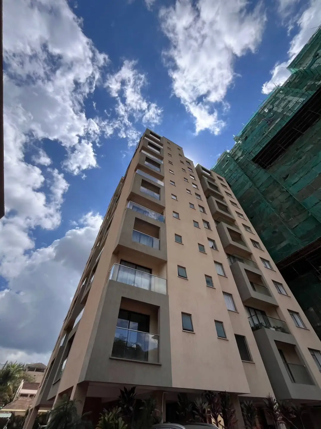 Multi-story residential building facade against blue sky