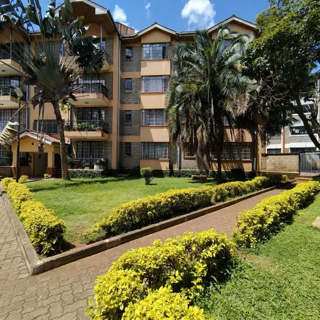 Multi-story residential building with manicured compound grounds
