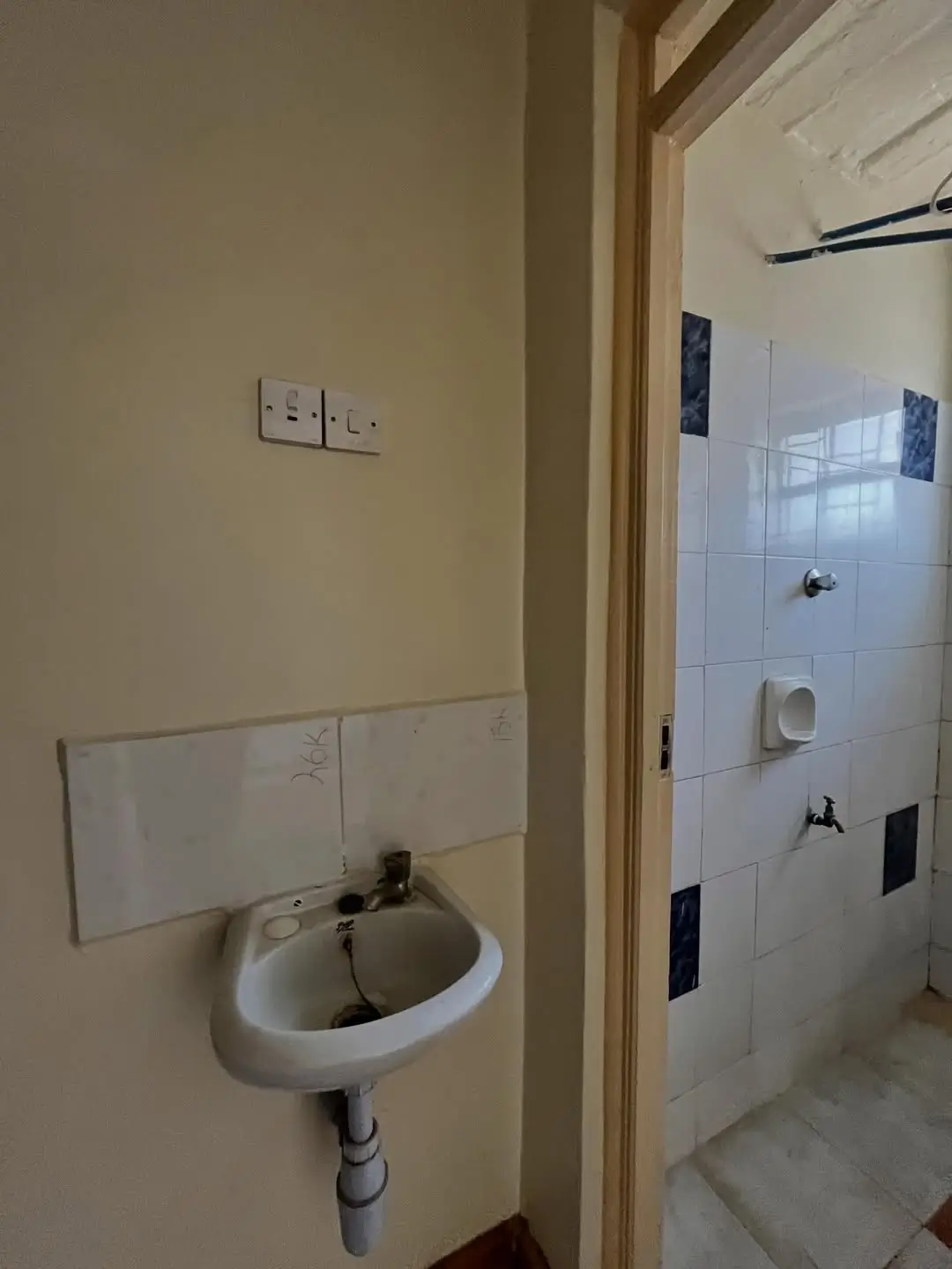 Bathroom with wall-mounted sink and tiled shower area