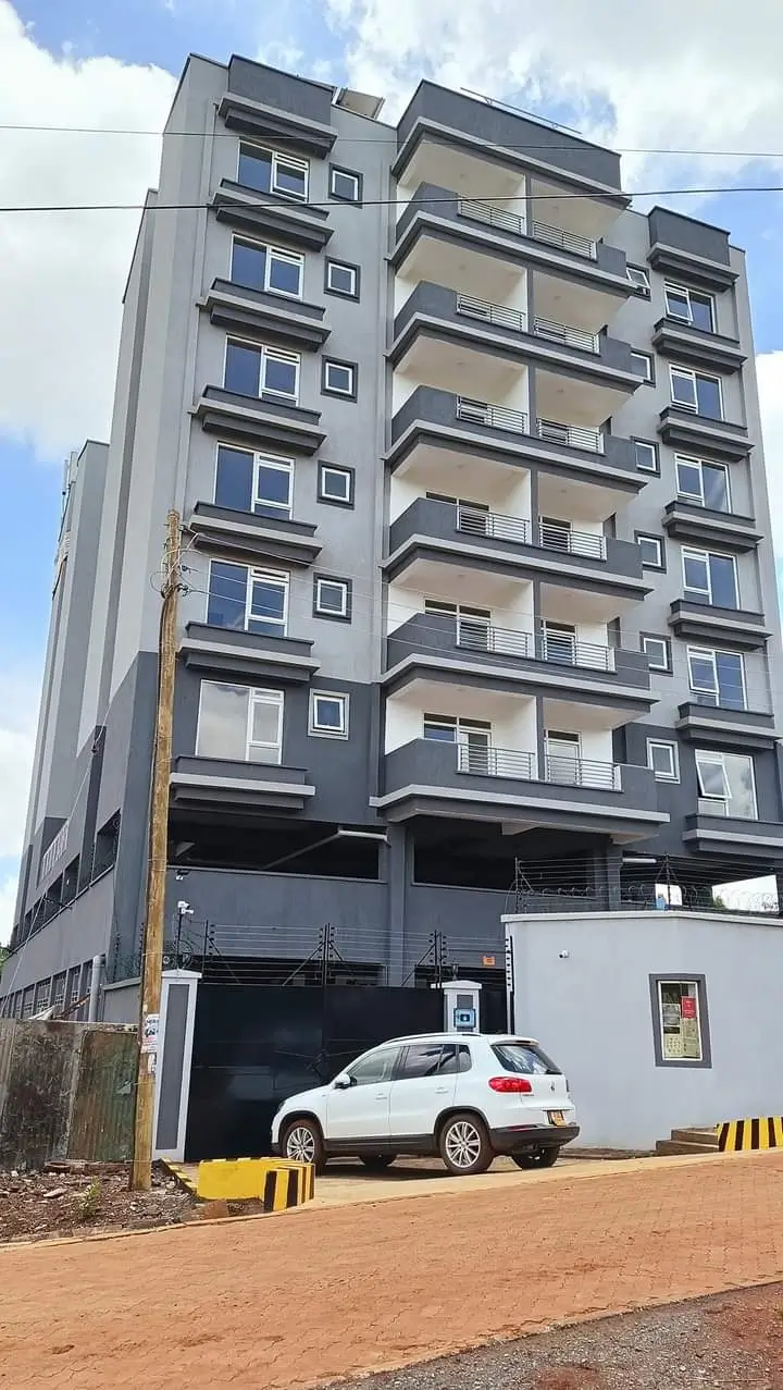 Modern residential building facade with ground-level parking bay