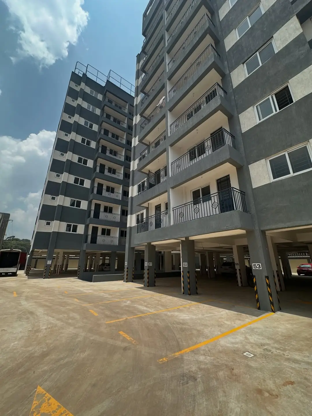 Ground-level parking bay with residential building facade above