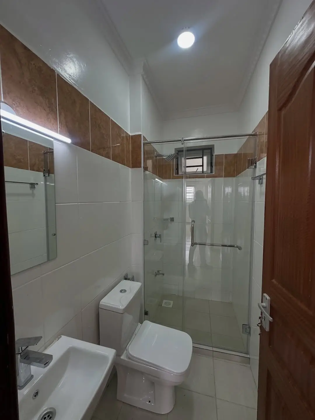 Modern bathroom with glass shower enclosure and white fixtures