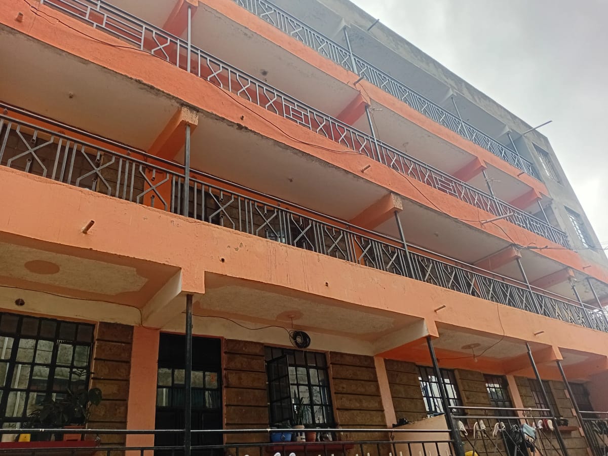 Multi-story residential building with orange facade and balconies