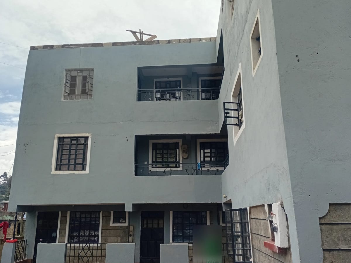 Modern white multi-story residential building with balconies