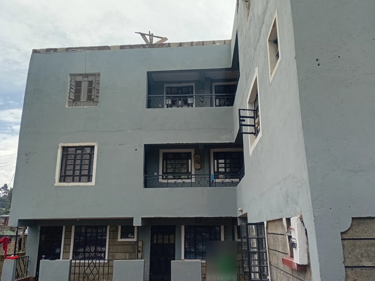 Modern white multi-story residential building with balconies