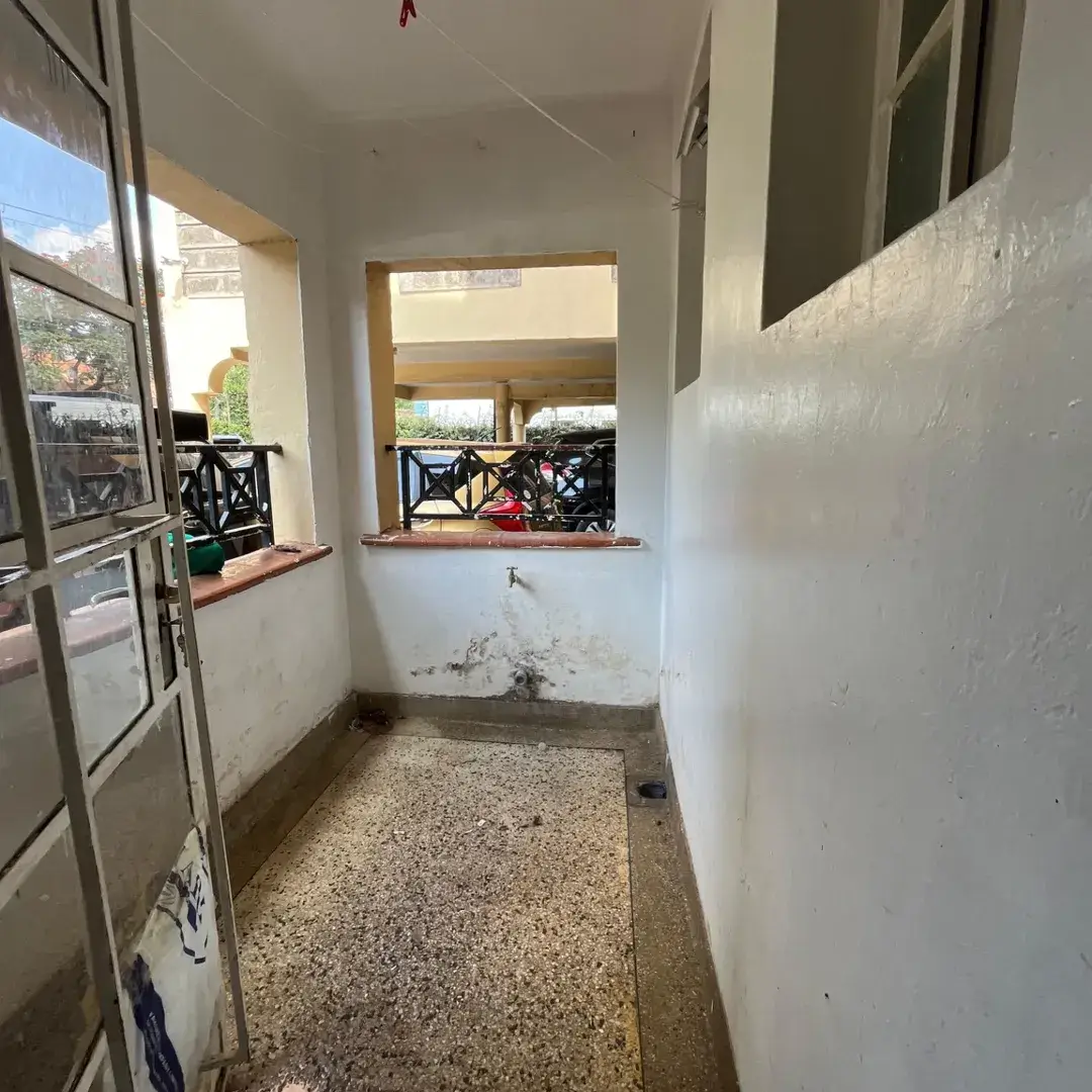 Narrow corridor with windows overlooking compound area
