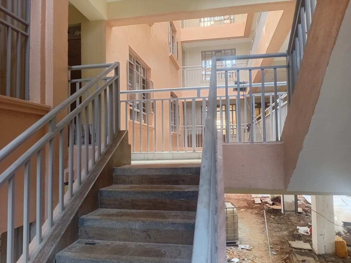 Interior staircase with metal railings and natural light