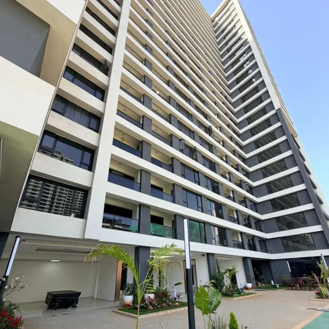 Modern high-rise residential building facade with ground-level parking