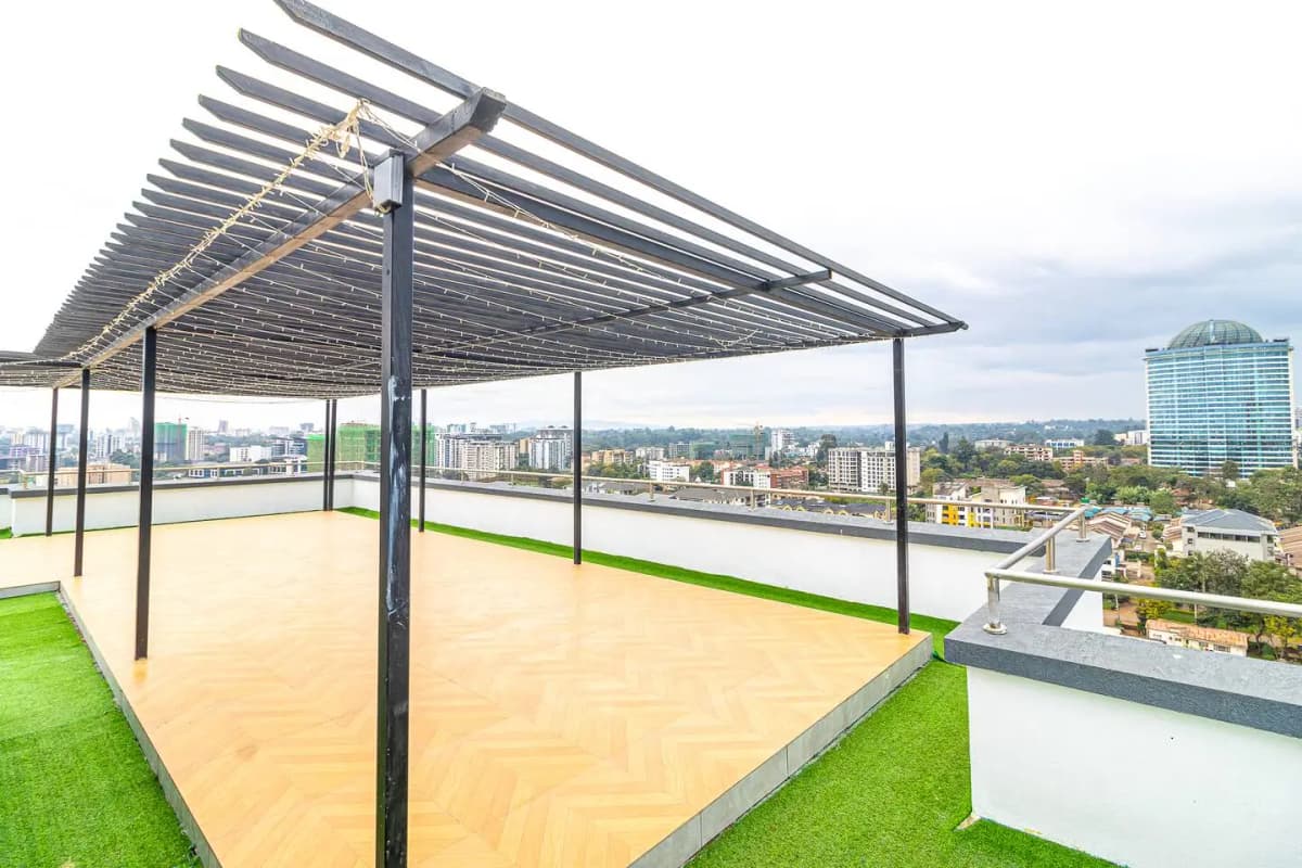 Rooftop terrace with pergola, artificial grass, city skyline views