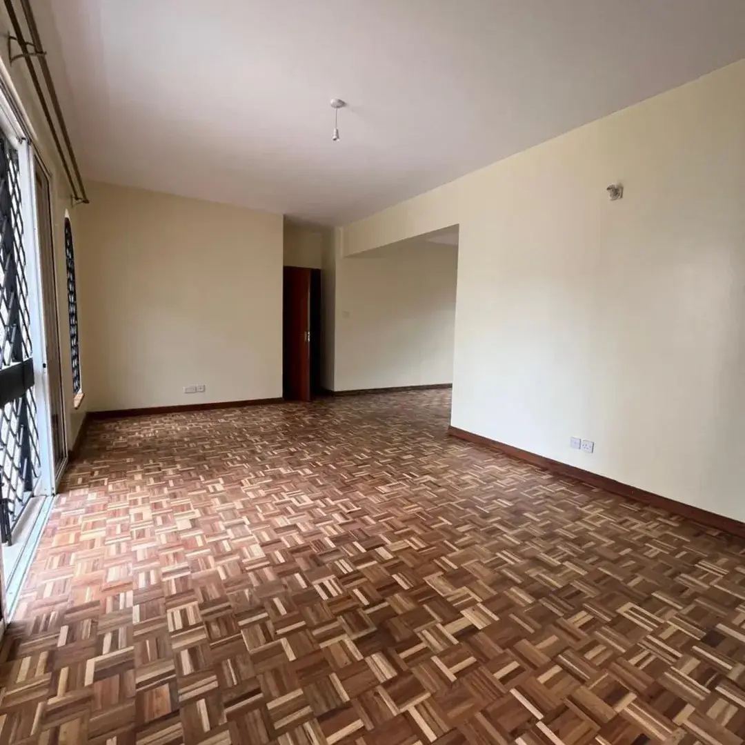 Spacious empty living room with herringbone parquet flooring