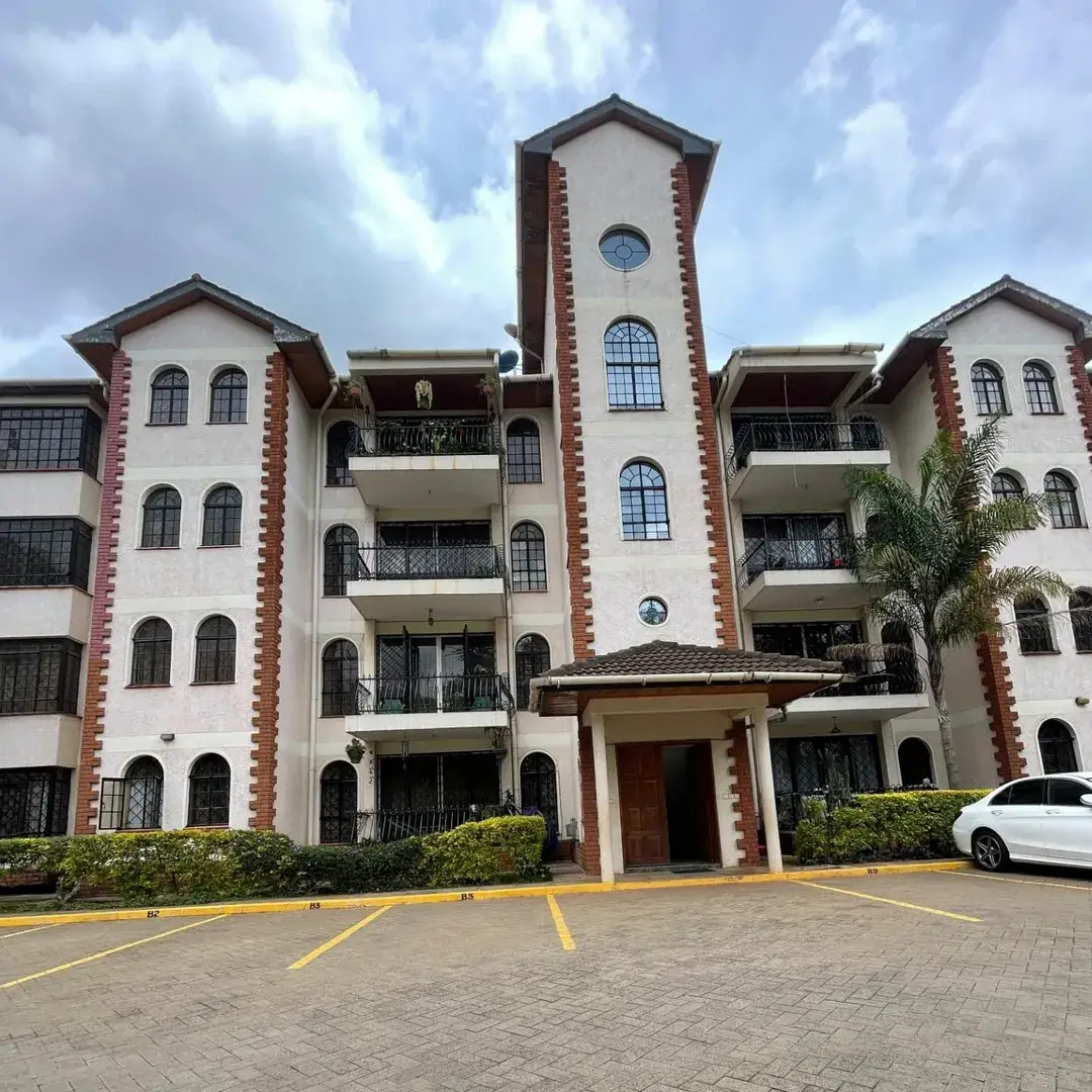 Multi-story residential building with distinctive tower and balconies