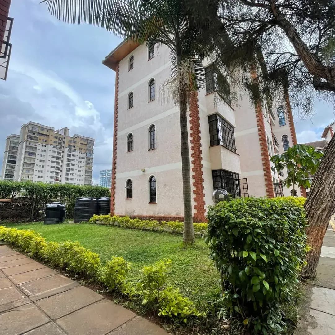 Colonial-style building facade with manicured compound grounds