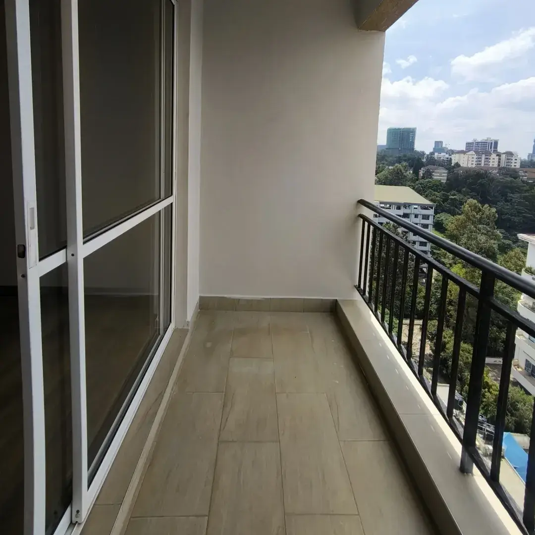 High-rise balcony with city skyline view and black railings