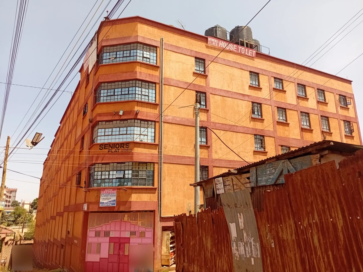 Orange residential building facade with multiple floors and balconies