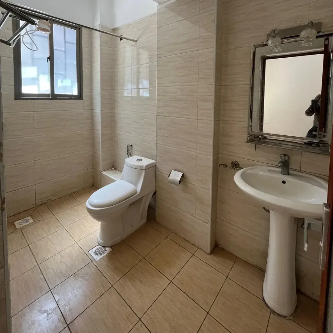 Clean bathroom with toilet, pedestal sink, and shower enclosure