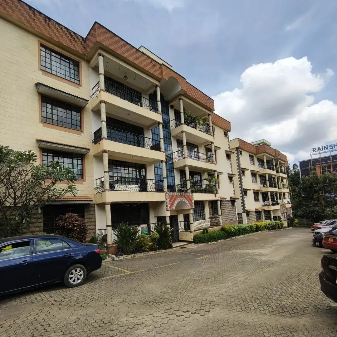 Multi-story residential building with parking compound and landscaping