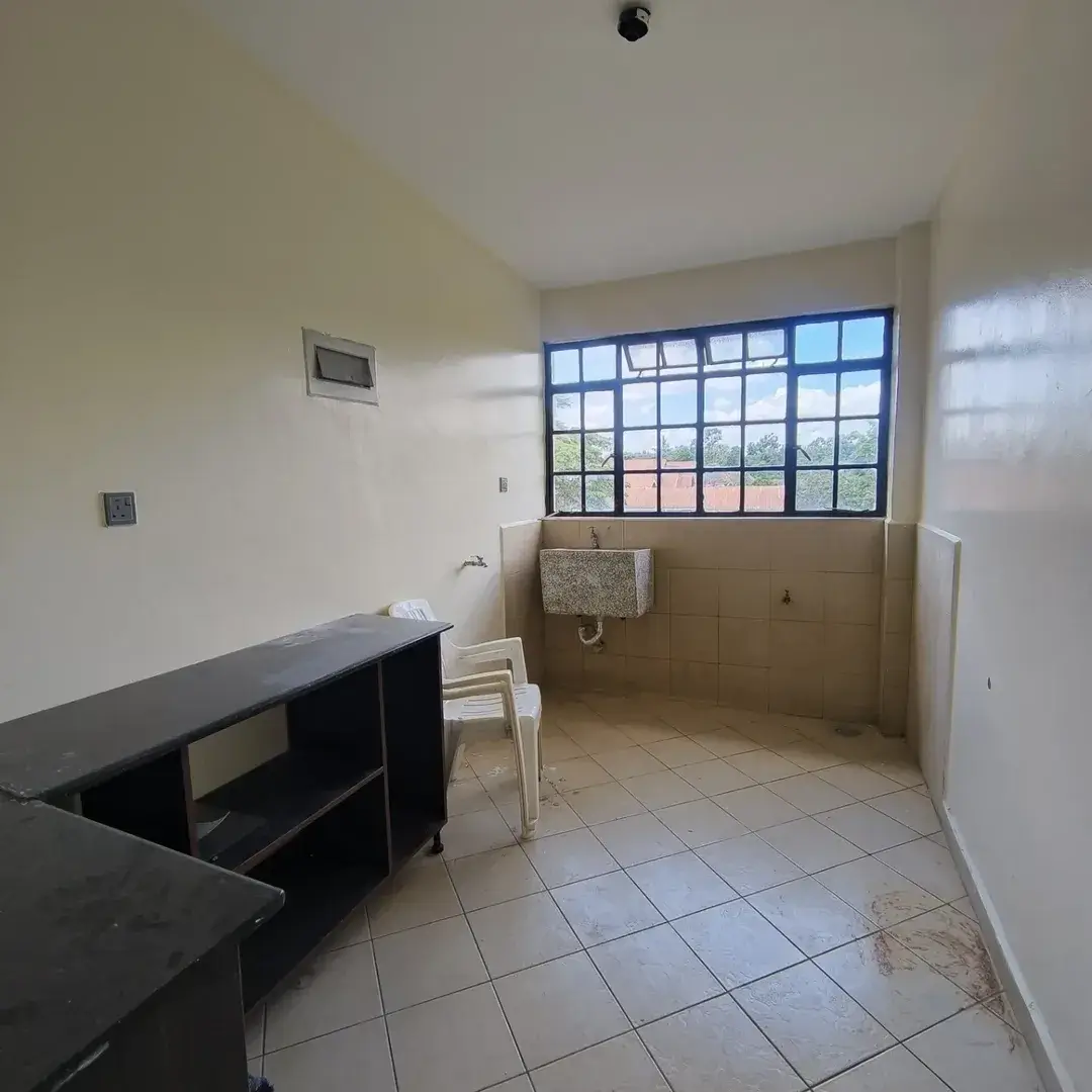 Kitchen with black countertop and large gridded window