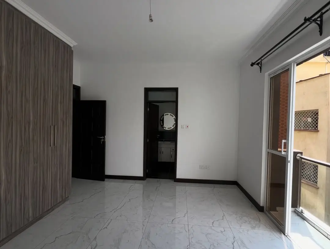 Spacious bedroom with built-in wardrobe and balcony access